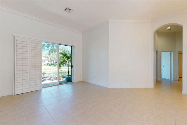 9515 E Maiden Ct, Vero Beach, FL 32963 - unfurnished room with visible vents, crown molding, arched walkways, light tile patterned floors, and baseboards