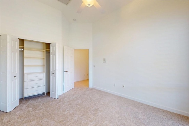 9515 E Maiden Ct, Vero Beach, FL 32963 - unfurnished bedroom with a closet, light colored carpet, a towering ceiling, ceiling fan, and baseboards