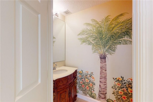 9515 E Maiden Ct, Vero Beach, FL 32963 - bathroom with a textured ceiling, visible vents, and vanity