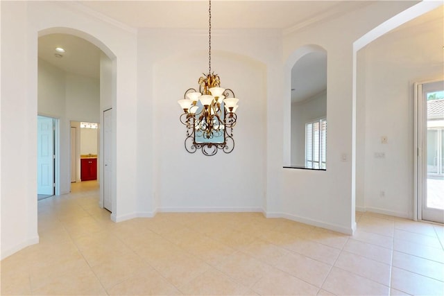 9515 E Maiden Ct, Vero Beach, FL 32963 - unfurnished dining area with crown molding, light tile patterned floors, a healthy amount of sunlight, and arched walkways