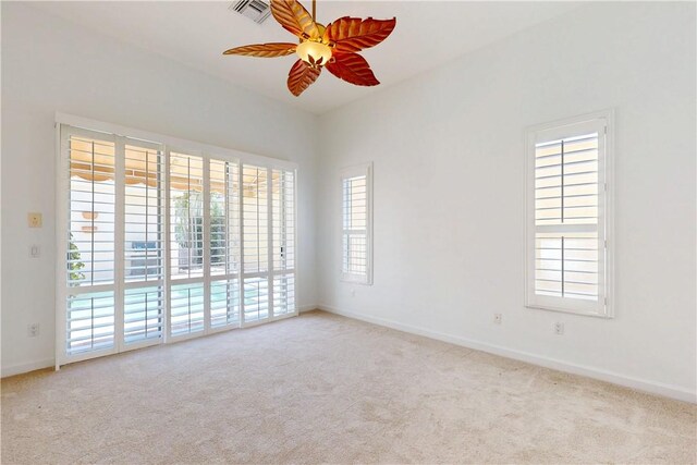 9515 E Maiden Ct, Vero Beach, FL 32963 - spare room with ceiling fan, a wealth of natural light, carpet floors, and visible vents