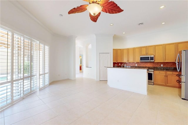 9515 E Maiden Ct, Vero Beach, FL 32963 - kitchen with stainless steel appliances, tasteful backsplash, a ceiling fan, and light tile patterned floors