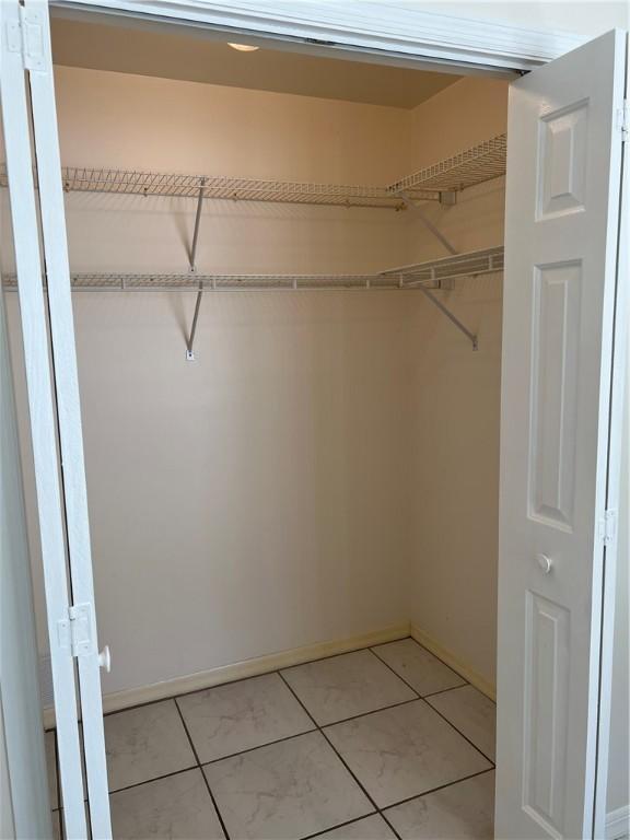 tiled bedroom with ceiling fan