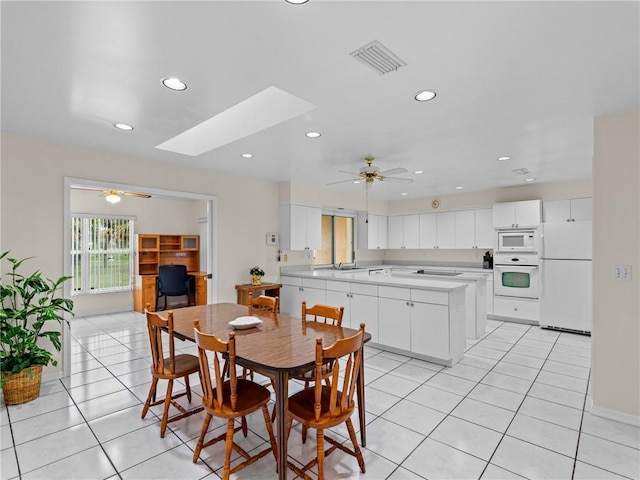992 Seneca Ave, Sebastian, FL 32958 - dining room featuring ceiling fan, light tile patterned flooring, recessed lighting, and a skylight