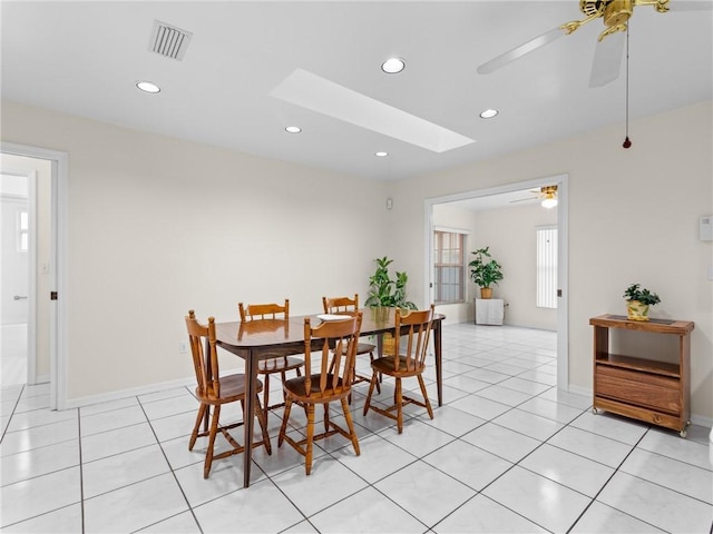 dining area featuring light tile patterned floors, a skylight, recessed lighting, and ceiling fan