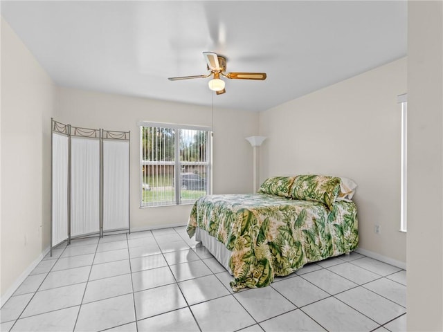 tiled bedroom featuring ceiling fan