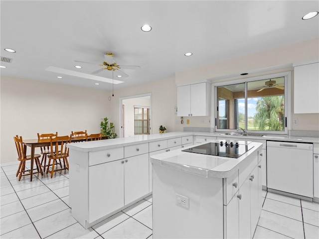 kitchen featuring a ceiling fan, a peninsula, light countertops, black electric stovetop, and dishwasher