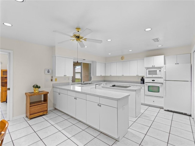 992 Seneca Ave, Sebastian, FL 32958 - kitchen with white appliances, light tile patterned floors, light countertops, and recessed lighting