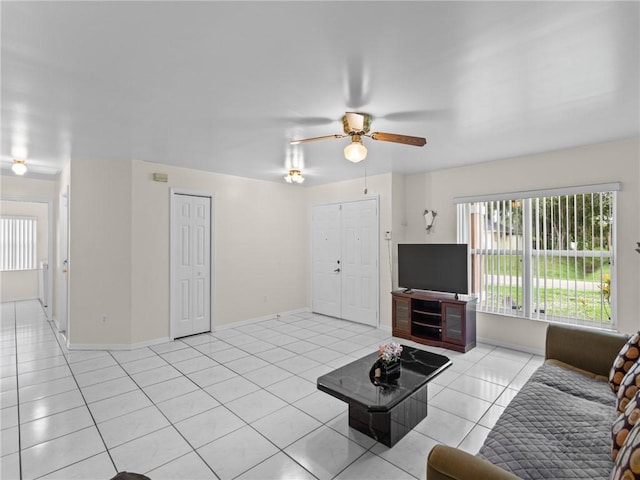 992 Seneca Ave, Sebastian, FL 32958 - living area with light tile patterned floors, a ceiling fan, and healthy amount of natural light