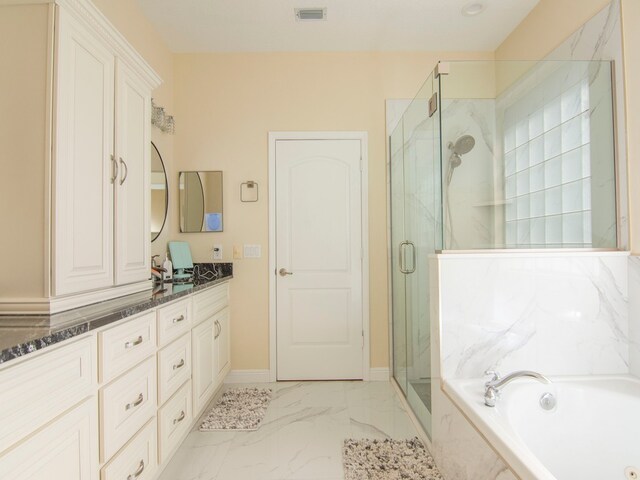 bathroom featuring vanity and shower with separate bathtub