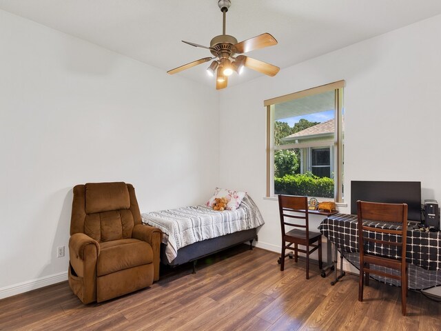 bedroom with dark wood-type flooring and ceiling fan