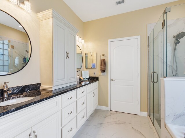 bathroom featuring vanity and a shower with shower door