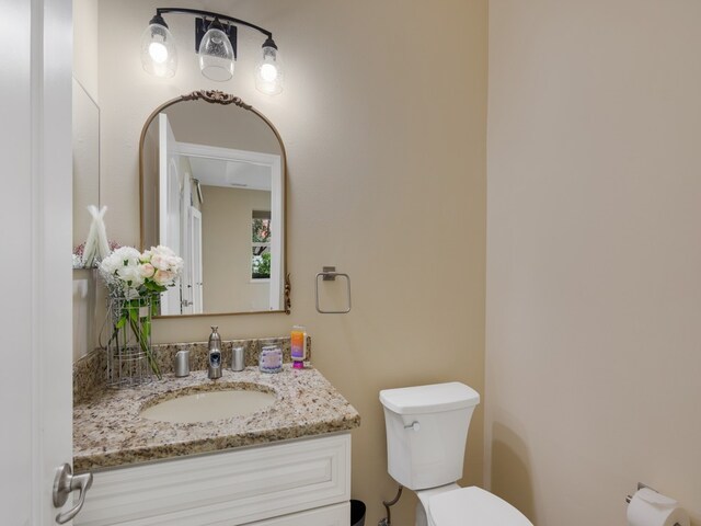 bathroom featuring toilet and vanity