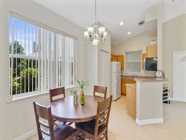 dining area featuring lofted ceiling, sink, a notable chandelier, and light tile patterned flooring