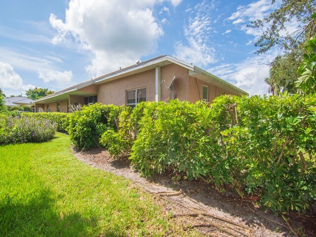 view of side of property with a lawn