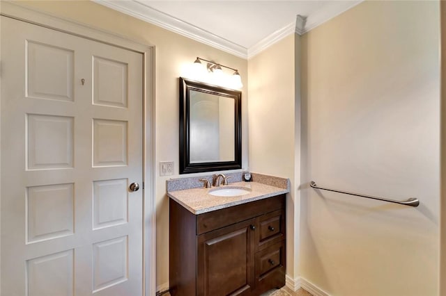 bathroom featuring crown molding and vanity