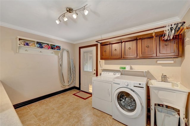 laundry room with cabinets, separate washer and dryer, and crown molding