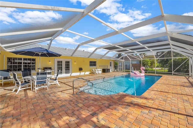 view of pool featuring a patio area, a lanai, and french doors