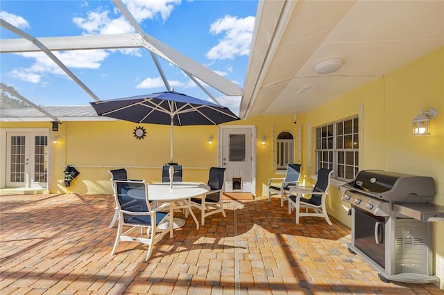 view of patio / terrace with french doors, area for grilling, and a lanai