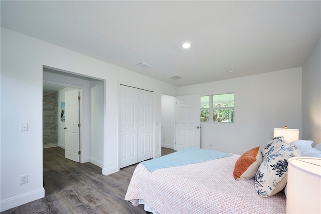 bedroom with hardwood / wood-style floors and a closet