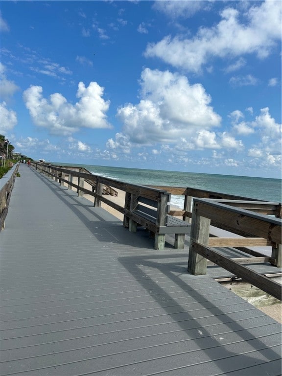 dock area with a beach view and a water view