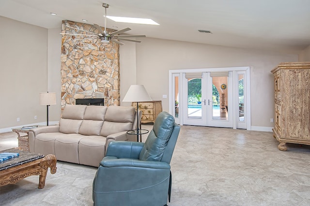 living room featuring a fireplace, french doors, vaulted ceiling, and ceiling fan