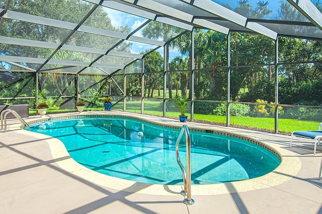 view of swimming pool with a lanai and a patio area