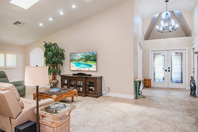 living room with a chandelier, french doors, and high vaulted ceiling