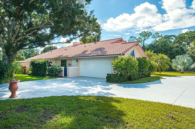 view of front of property featuring a garage and a front yard