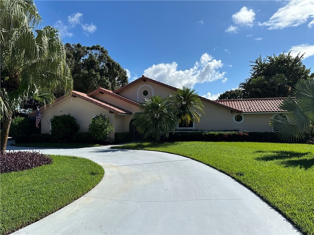 mediterranean / spanish house with a front yard