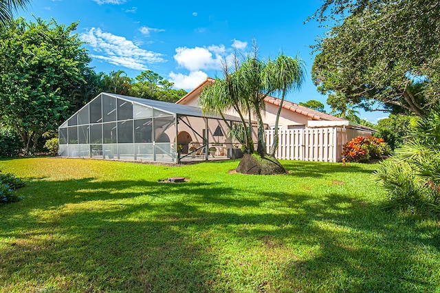 view of yard with glass enclosure