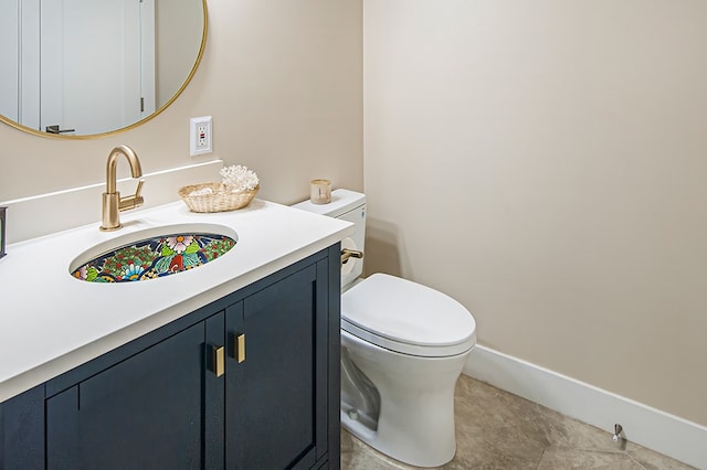 bathroom featuring tile patterned floors, vanity, and toilet