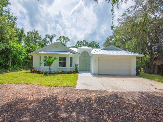 single story home featuring a front lawn and a garage