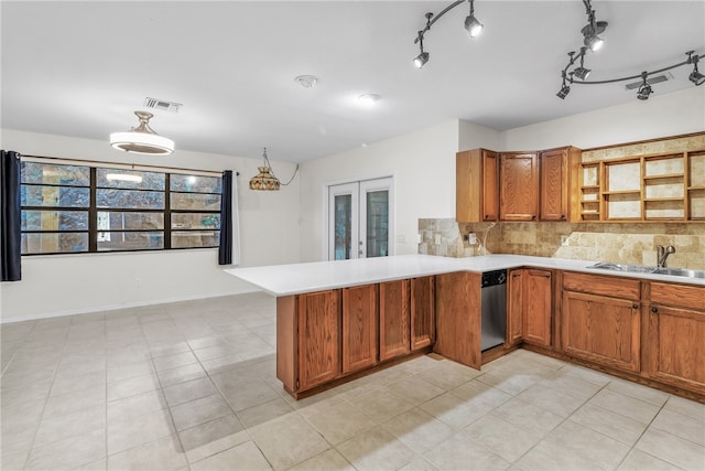 kitchen with dishwasher, french doors, sink, decorative backsplash, and kitchen peninsula