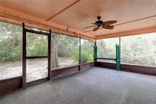 unfurnished sunroom with ceiling fan