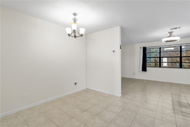 unfurnished room with a notable chandelier