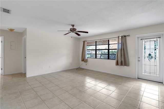 empty room featuring ceiling fan and light tile patterned floors