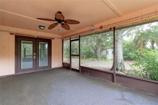 unfurnished sunroom with ceiling fan