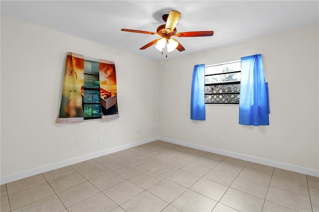 tiled empty room with ceiling fan