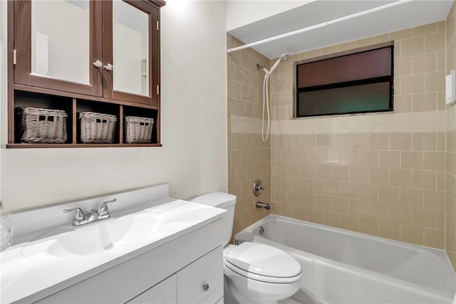 full bathroom with toilet, vanity, and tiled shower / bath