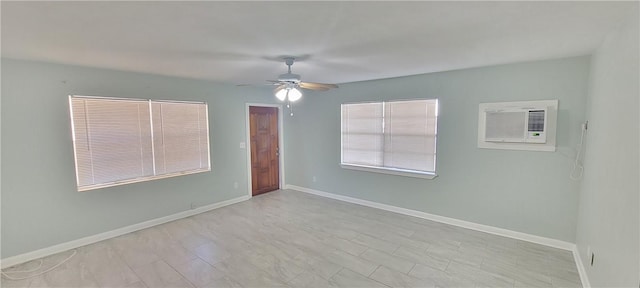 unfurnished room with a wall mounted air conditioner and ceiling fan