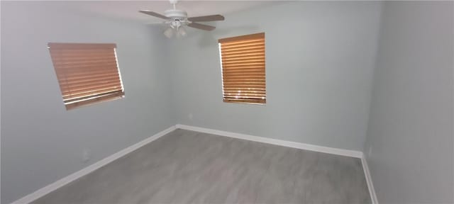 empty room featuring ceiling fan and hardwood / wood-style floors