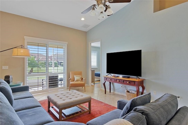 tiled living room featuring lofted ceiling and ceiling fan