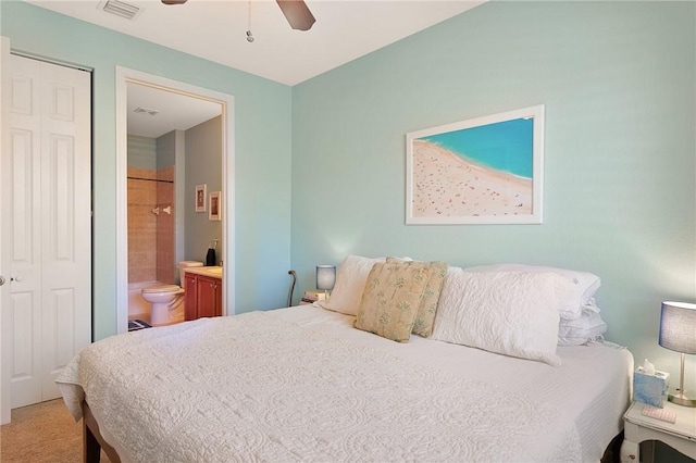 carpeted bedroom with connected bathroom and ceiling fan