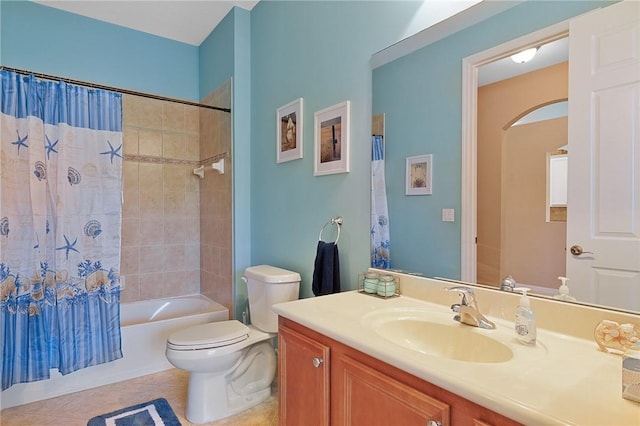 full bathroom with tile patterned floors, vanity, toilet, and shower / bath combo with shower curtain