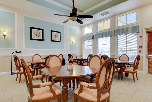 dining space with ornamental molding, a ceiling fan, visible vents, and baseboards