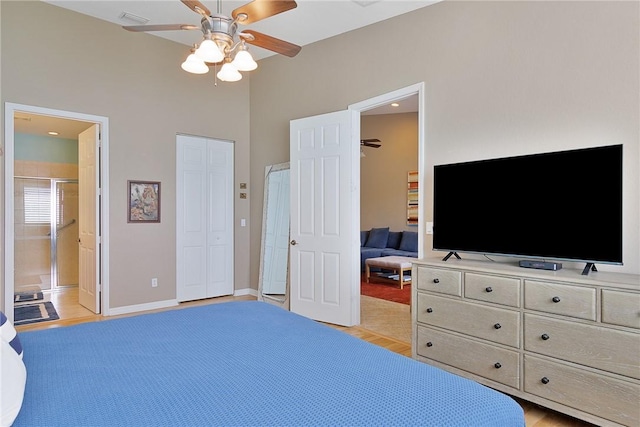 bedroom featuring ceiling fan, ensuite bathroom, and light wood-type flooring