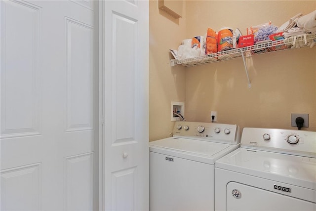 laundry room with washing machine and clothes dryer