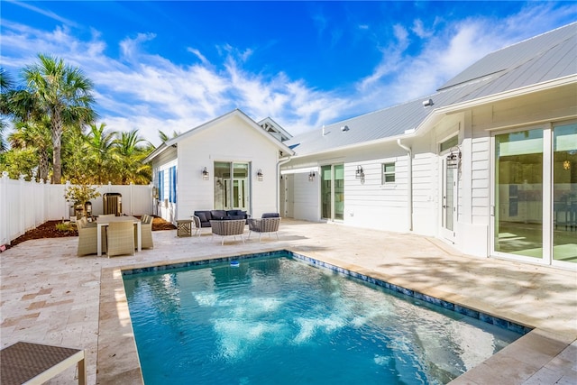 back of house with a fenced in pool, outdoor lounge area, and a patio