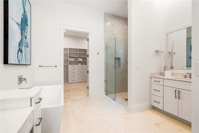 bathroom with vanity and shower with separate bathtub